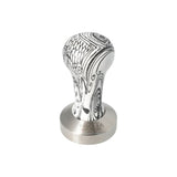 Motta 53mm coffee tamper with flat base and black & white wooden handle, designed for precise espresso tamping and elegant countertop display.